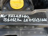 a close up of a car engine with a yellow cap on it