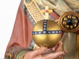 a statue of a man holding a golden ball