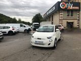 a small white car parked in front of a building