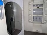 a shower in the corner of a bathroom with a glass door