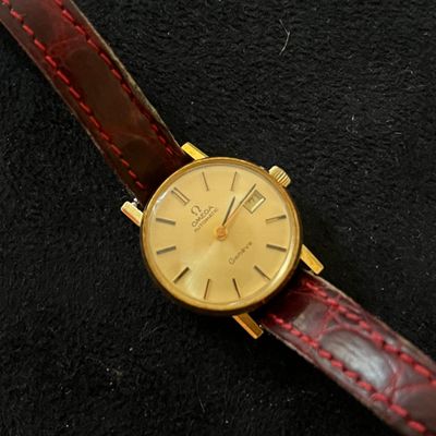 an image of a close up of a wrist watch on a black surface