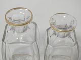 pair of clear glass salt and pepper shakers with gold rims
