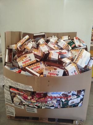 a cardboard box filled with assorted candy and candy bars