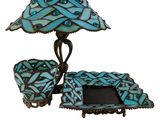 an image of a table with a lamp and a picture frame on it