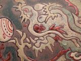 a vase with a dragon on it sitting on a table