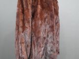 a close up of a fur coat on a mannequin stand