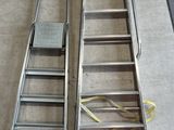 a ladder that is sitting on the floor next to other ladders
