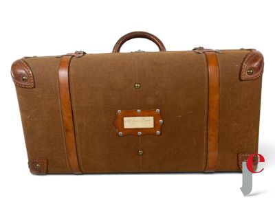a brown piece of luggage sitting on a white surface