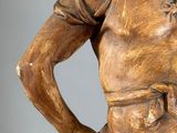 bronze statue of a man with his hands on his hips