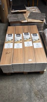 several stacks of wood planks stacked on top of each other in a warehouse