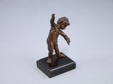bronze statue of a boy holding a baseball bat on a marble base