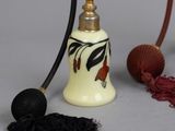 a small bell with a handle next to a ball of yarn and a ball of yarn