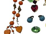 a lot of jewelry that is laying out on a white surface