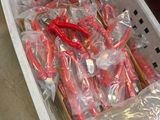 a plastic basket filled with red and white toothbrushes