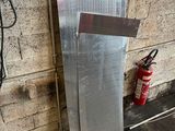 an image of a refrigerator in a garage with a fire extinguisor