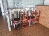 many chairs that are lined up in the corner of the room