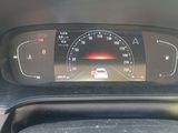a car dashboard with a speedometer and a dash light