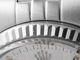 a close up of a watch with a metal bracelet
