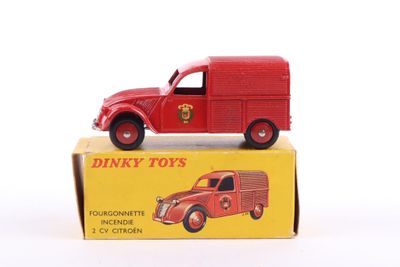 a red toy truck sitting on top of a yellow box