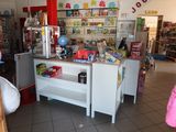 a woman that is standing in front of a store counter