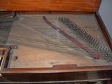 a piano that is sitting on a table with strings