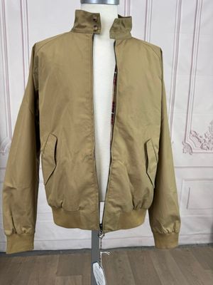 jacket on a mannequin stand in front of a white wall
