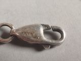a close up of a metal clasp on a white surface