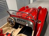 a red car that is parked inside of a garage