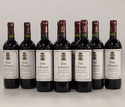 six bottles of wine are lined up on a table