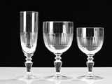 three empty wine glasses sitting on a white table