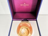 an image of a bottle of perfume in a purple box