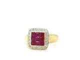 a close up of a gold ring with a red stone surrounded by diamonds