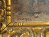 a close up picture of a gold frame with a picture on it
