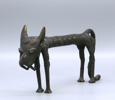 statue of a dog with horns on a white surface with a gray background