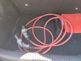 a red hose in the trunk of a car