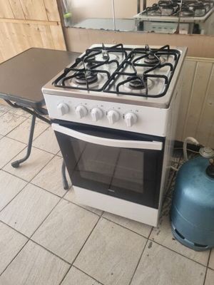 a gas stove and a table in a kitchen