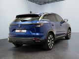 the rear end of a blue car parked in a garage
