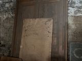 a room with a door, a window, and a chair in it