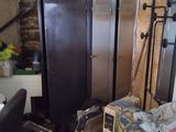 an image of a cluttered room with a bed and a desk