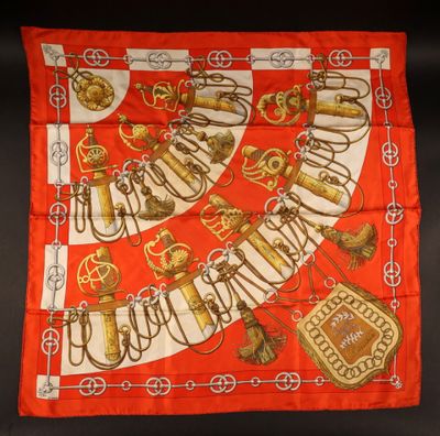 a red and white scarf with gold letters and symbols on it
