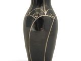 a black vase that has a design on it