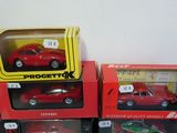 three boxes of toy cars sitting on a table