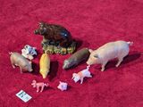 a lot of toy animals that are on a red surface