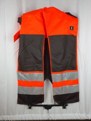 an orange and black safety vest hanging on a wall
