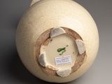 a white vase with a hole in the middle of it