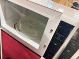 a microwave that has a glass door on the inside of it