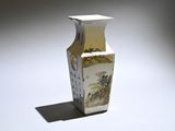a white vase with a painting on it sitting on a table