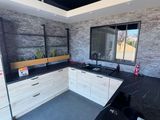 a kitchen with a black counter top and white cabinets