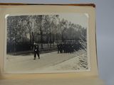 an old photo of a person holding a picture of a man walking down a street