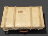 an old suitcase sitting on top of a table